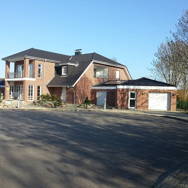 Wohngebäude mit Balkonen und Klinkerfassade an der Ostseeküste – Bauarbeiten durch Bauunternehmen aus Ostholstein